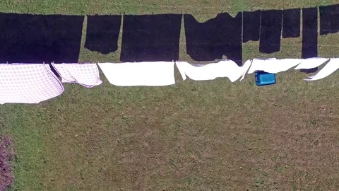 Aerial of clothes hanging on a clothesline Stock Footage