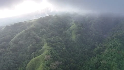 Aerial of Clouds and Rainforest on Slopes of Indonesian Volcano Near Komodo Stock Footage 248309321