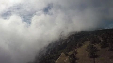 Aerial of clouds float over the mountains, sky, forest, trees, dry grass Stock Footage 57260173