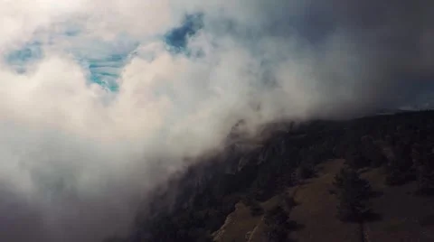 Aerial of clouds float over the mountains, sky, forest, trees, dry grass Stock Footage 57260188