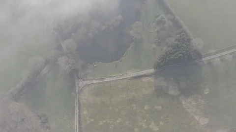 Aerial - clouds moving above a pond and fields Stock-Footage 101715922