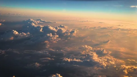 Aerial of clouds over the blue sky. shooting from inside an airplane. Video stock 93698735