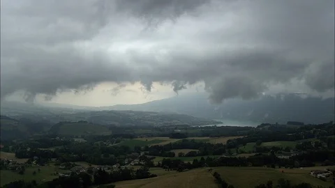 Aerial of clouds over rolling hills covered in grass, Stormy Weather Stock Footage 108607493