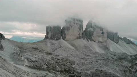 Aerial: Clouds in three peaks (Tre Cime/ Drei Zinnen) of Lavaredo in Dolomites Stock Footage 151296507