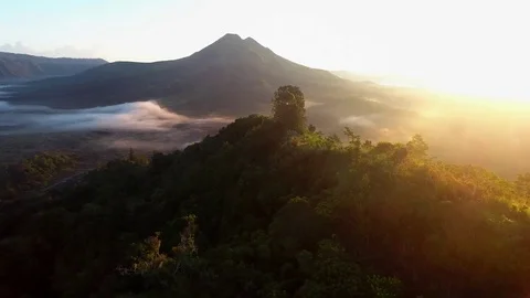 Aerial of cloudscape and mountain covered with green forest at sunset Stock Footage 81522945