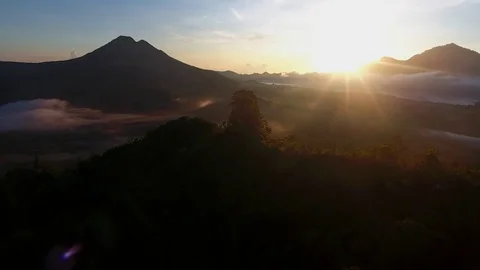 Aerial of cloudscape and mountain covered with green forest at sunset Stock Footage 81522962