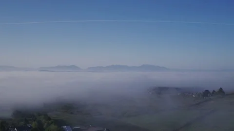 Aerial Of Cloudscape Covering Fields Against Vapor Trail In Sky Stock Footage 79654610