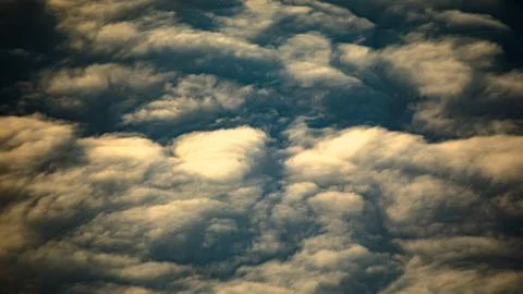 Aerial cloudscape with a dynamic sky full of fluffy clouds stretching as far as Stock Photos