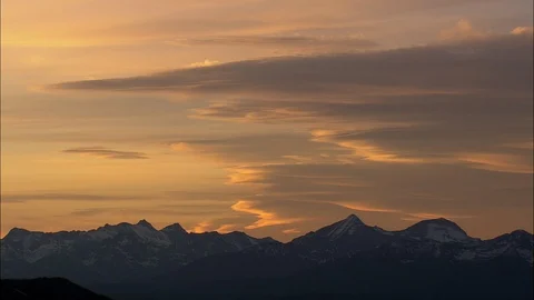 Aerial of cloudy sky at sunset above mountain ranges, Big purple sky at sunset Stock Footage 109454409