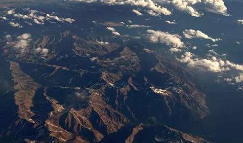 Aerial cloudy view. Landscape from plane. Top of mountain in cloud. Landscape Stock Photos