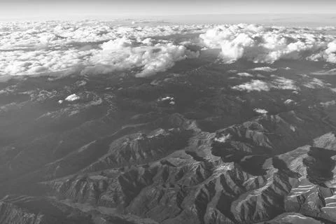 Aerial cloudy view. Landscape from plane. Top of mountain in cloud. Landscape Stock Photos