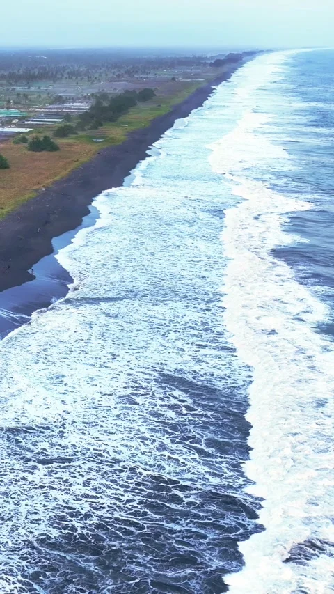 Aerial coastline with powerful waves and dark beach Stock Footage 335432845