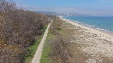 Aerial coastline with road running parallel to beach and sea Stock Footage 331712693