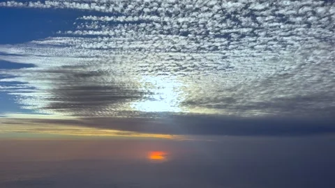 Aerial Cockpit View of a Layer of Parallel Altocumulus Clouds in a Blue Sky at Stock Footage 340338352