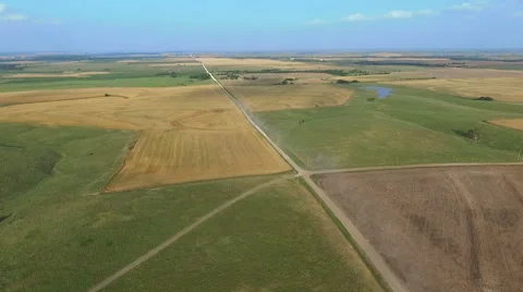 Aerial of Combines Moving Between Wheat Fields (Kansas USA) Vídeo Stock 61736583