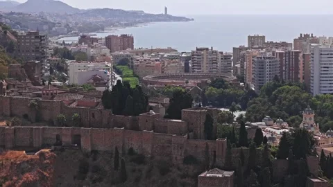 Aerial compressed view of Malaga Alcazaba aligned with bullring and distant Stock Footage 334633696