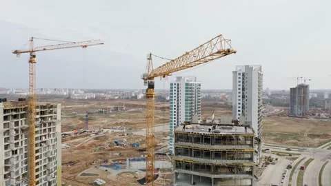 Aerial construction with high tower cranes working on building site in city Stock Footage 152529487