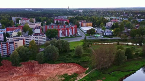 Aerial Construction Scene with Excavated Plot for Residential Bulding and City Stock Footage 325956989