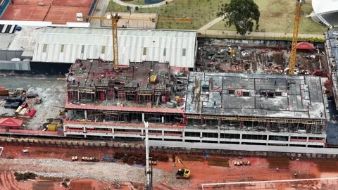 Aerial Construction Site with Yellow Tower Cranes and Concrete Building Stockbeeldmateriaal 344478021