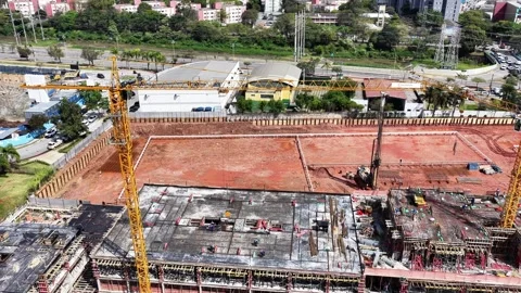 Aerial Construction Site with Yellow Tower Cranes and Concrete Building 動画素材 344478029
