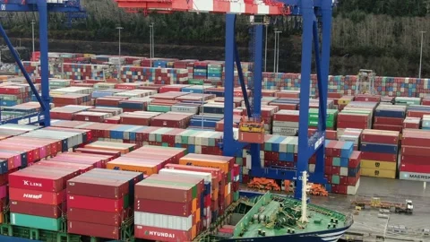 Aerial: Container crane loading containers onto a Container Ship Stock Footage 149898799