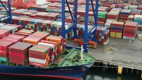 Aerial: Container crane loading containers onto a Container Ship Stock Footage 149898830