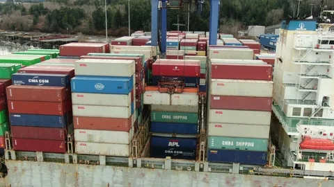Aerial: Container crane loading containers onto a Container Ship Stock Footage 149898854