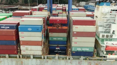 Aerial: Container crane loading containers onto a Container Ship Stock Footage 149898891