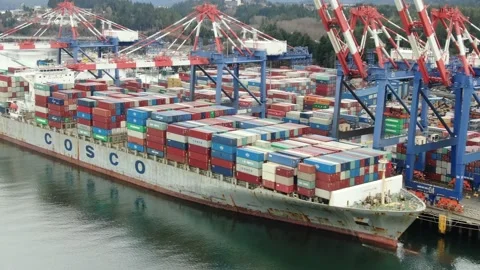 Aerial: Container crane loading containers onto a Container Ship Stock Footage 149899366