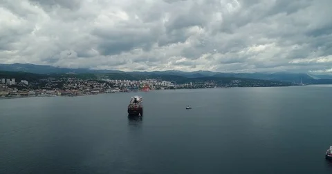 Aerial of container ship infront port on beautiful cloudy day Video stock 75475646