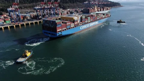 Aerial: Container ship starting up her engines with prop wash Stock Footage 149781746