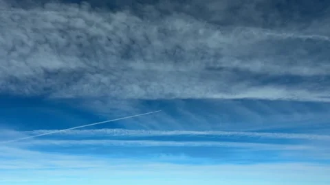 Aerial Coockpit View of Parallel Contrails Dissipating Under a Blue Sky with a Stock Footage 318958654