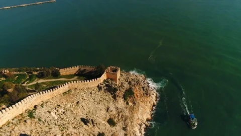 Aerial copter flight over old Alanya fortress on rocks overwashed by Stock Footage 86730600
