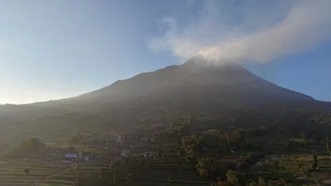 Aerial countryside panorama featuring Mount Merapi and surrounding farmland. Stock Footage 338428896