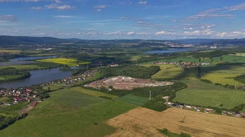 Aerial countryside panorama over patchwork fields, winding river, and small Stock Footage 346261748