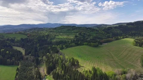 Aerial countryside panorama with patchwork fields, dense forests, rolling hills, Stock Footage 346261529