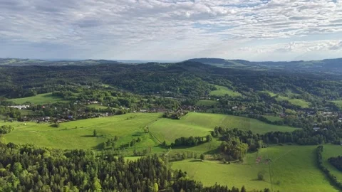 Aerial countryside panorama of patchwork fields and farm villages, winding Stock Footage 346261582