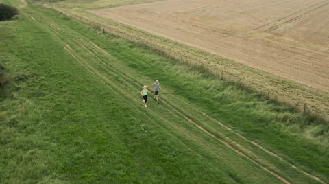 Aerial - Couple jogging in field Stock-Footage 59408733