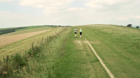 Aerial - Couple jogging in field Stock Footage 59408863