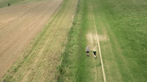 Aerial - Couple jogging in field Stock-Footage 59409247