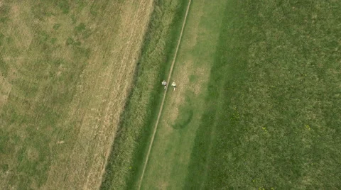 Aerial - Couple jogging in field Stock Footage 59409250