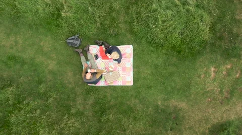 Aerial - Couple relaxing and having breakfast in field Stock Footage 59409128
