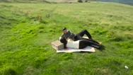 Aerial - Couple Relaxing In Field Stock Footage