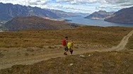 Aerial Couple Walking On Road Fjordland New Zealand Stock Footage