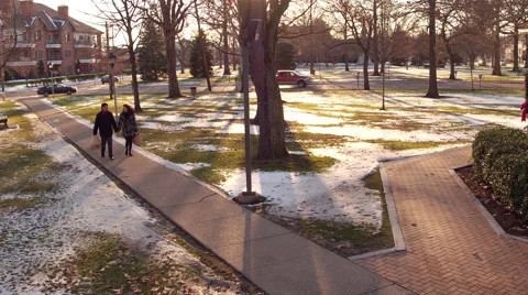 Aerial of couple walking through park at Christmas Stock Footage 59169292