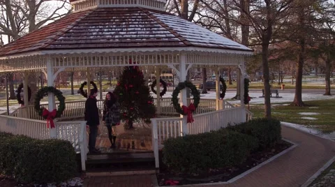 Aerial of couple walking through park at Christmas Stock Footage 59169309