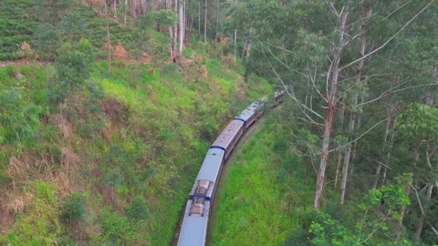 Aerial Crane Up Drone Shot of Train Moving Through Tropical Green Mountains Stock Footage 321613639