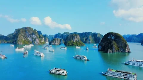 Aerial crane shot elevating to reveal panoramic Ha Long Bay cruise ships 4K Stock Footage 336650989