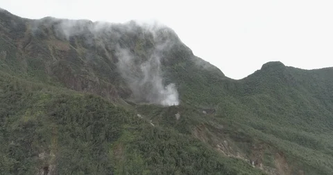 Aerial crests a ridge while moving towards the Boiling Lake in Dominica Stock-Footage 99595643
