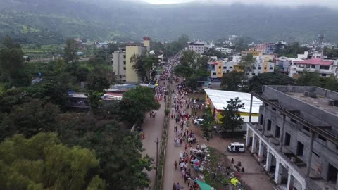 Aerial of the crowd of Hindu devotees approaching a junction while taking Stock Footage 254674387